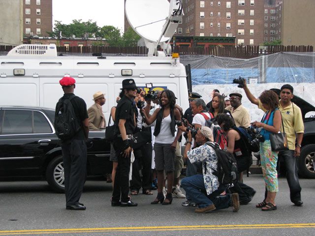 Media and a Michael Jackson impersonator on West 125th Street